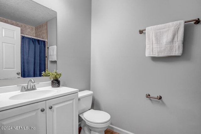 bathroom featuring vanity, toilet, and a shower with curtain