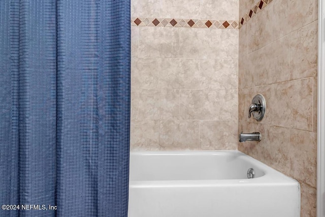 bathroom with shower / bath combination with curtain