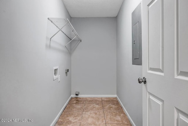 laundry area featuring electric panel, light tile patterned flooring, hookup for a washing machine, and electric dryer hookup