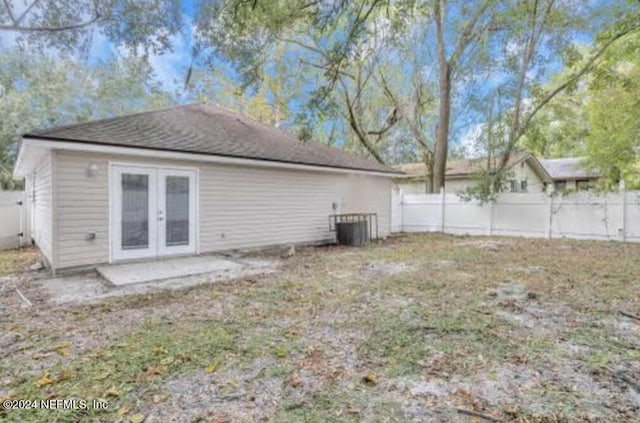 rear view of house with french doors and cooling unit