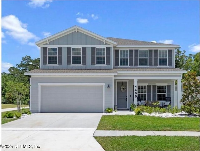 view of front of house featuring a front yard and a garage