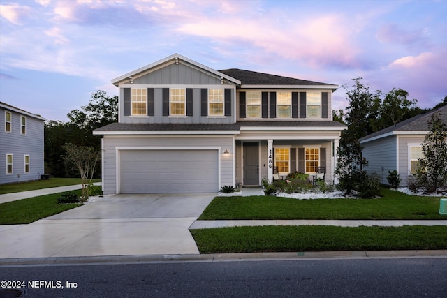 view of front of house with a lawn and a garage