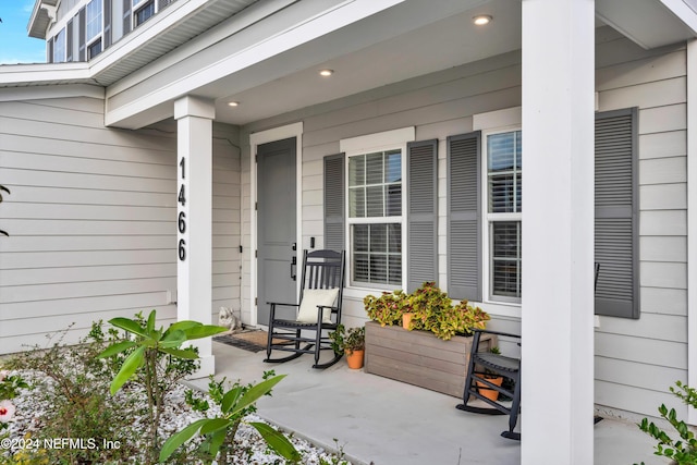 view of exterior entry featuring covered porch