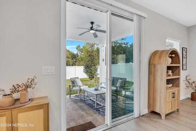 doorway featuring light hardwood / wood-style flooring, a wealth of natural light, and ceiling fan