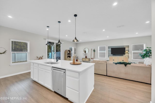 kitchen with dishwasher, sink, light hardwood / wood-style flooring, a center island with sink, and white cabinets