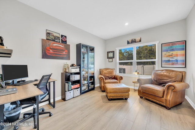 home office with light hardwood / wood-style floors