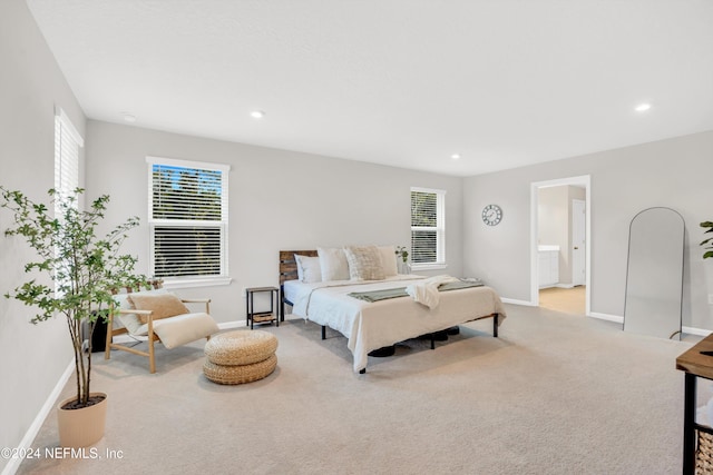 carpeted bedroom with ensuite bath