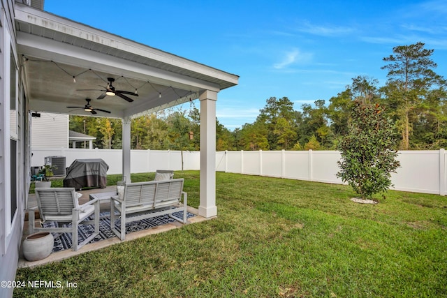 view of yard featuring an outdoor living space, ceiling fan, and cooling unit