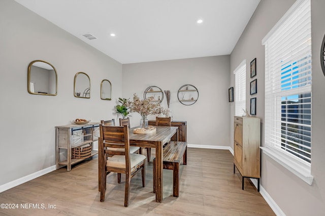 dining space with a wealth of natural light and light hardwood / wood-style flooring