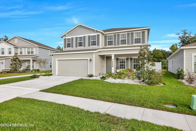 view of front of property featuring a garage and a front lawn