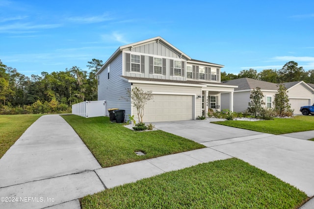 view of property with a garage and a front lawn