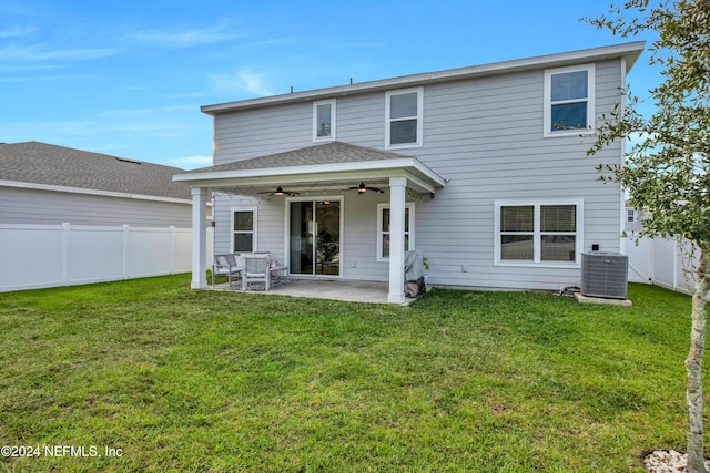 rear view of house featuring central air condition unit, ceiling fan, a patio area, and a lawn