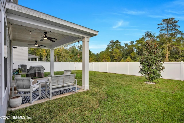 view of yard featuring central AC, ceiling fan, and an outdoor hangout area