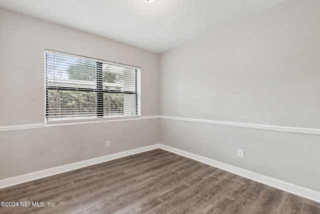 spare room with hardwood / wood-style flooring and a textured ceiling