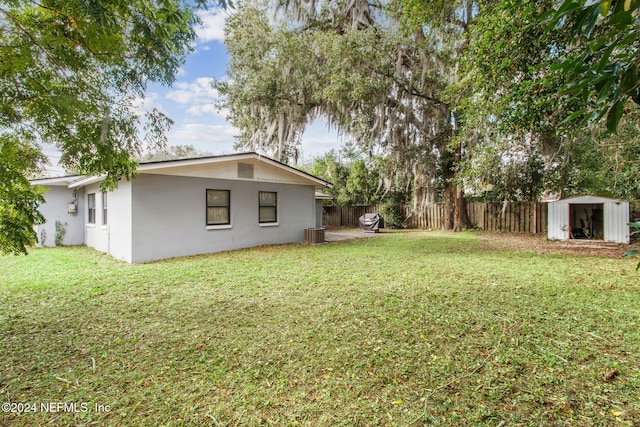 view of yard with a shed and central AC