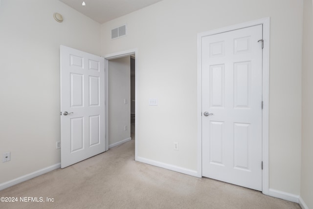 unfurnished bedroom with light carpet