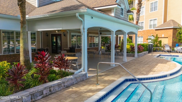 view of swimming pool with a patio and ceiling fan