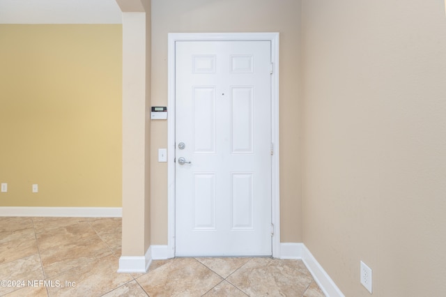 doorway to outside featuring light tile patterned flooring