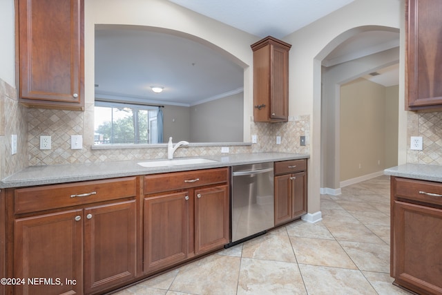 kitchen with dishwasher, light tile patterned floors, ornamental molding, decorative backsplash, and sink