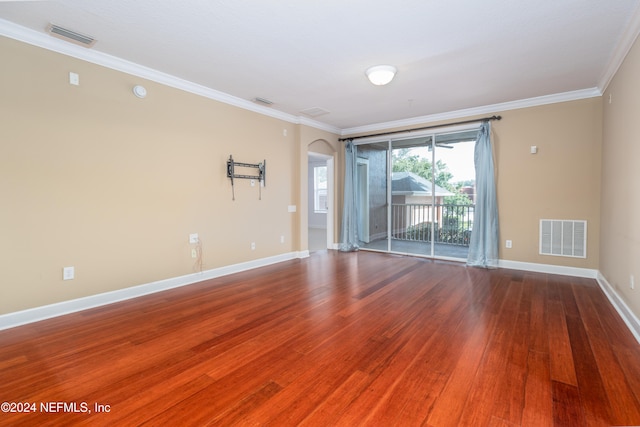 unfurnished room featuring ornamental molding and wood-type flooring