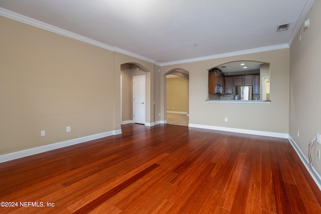 unfurnished room featuring hardwood / wood-style flooring and crown molding