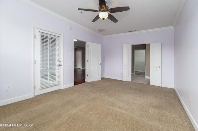 unfurnished bedroom with ceiling fan, crown molding, and carpet