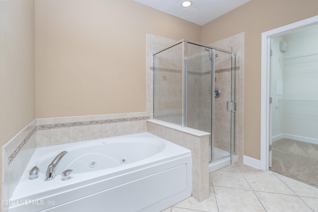 bathroom featuring tile patterned floors and separate shower and tub