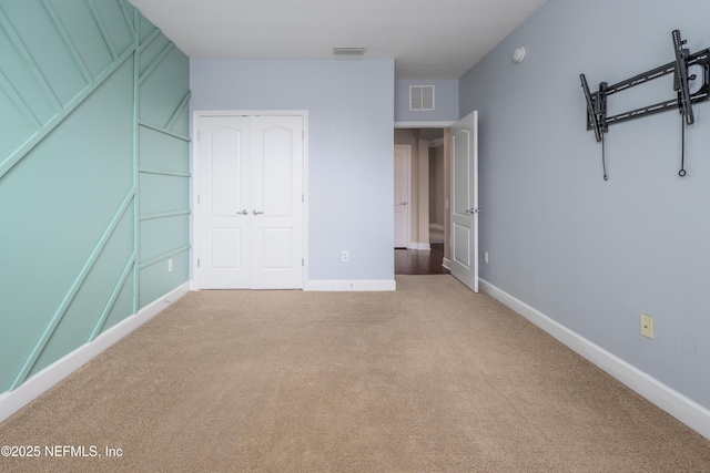 unfurnished bedroom with a closet and carpet floors