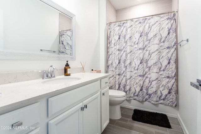 full bathroom with shower / bathtub combination with curtain, vanity, and toilet