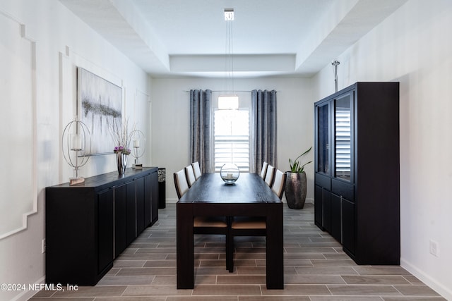 dining area with a raised ceiling