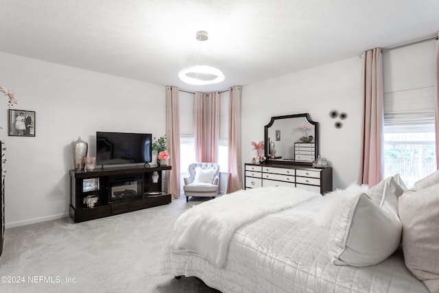 bedroom featuring light colored carpet