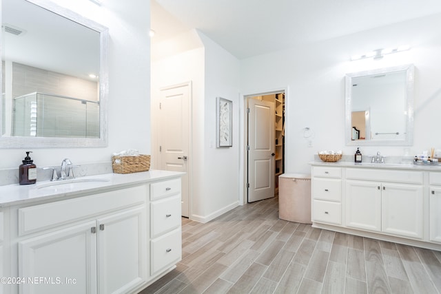 bathroom featuring vanity, wood-type flooring, and an enclosed shower