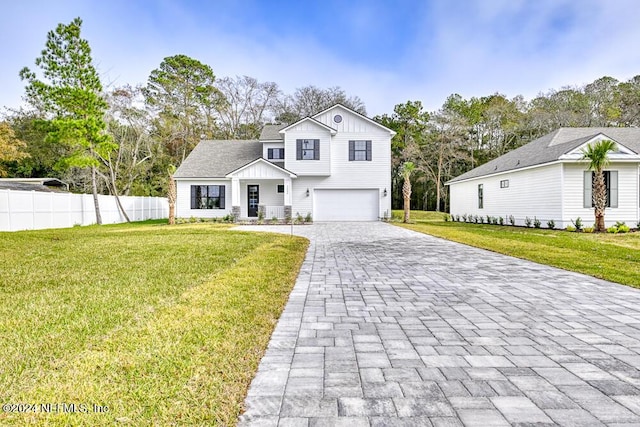 modern farmhouse with a front lawn and a garage