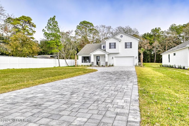 view of front of house with a front lawn and a garage