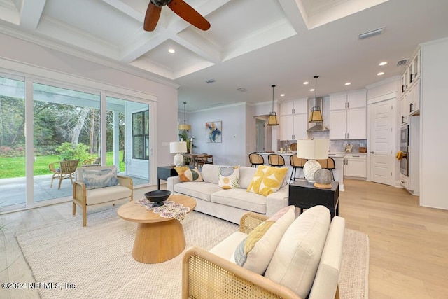 living room with ornamental molding, coffered ceiling, ceiling fan, beam ceiling, and light hardwood / wood-style flooring