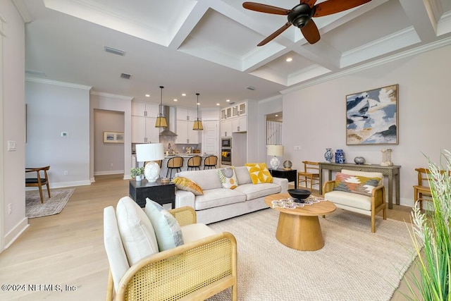 living room featuring coffered ceiling, ceiling fan, ornamental molding, beam ceiling, and light hardwood / wood-style floors