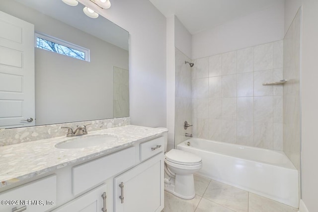 full bathroom featuring tile patterned floors, toilet, vanity, and tiled shower / bath