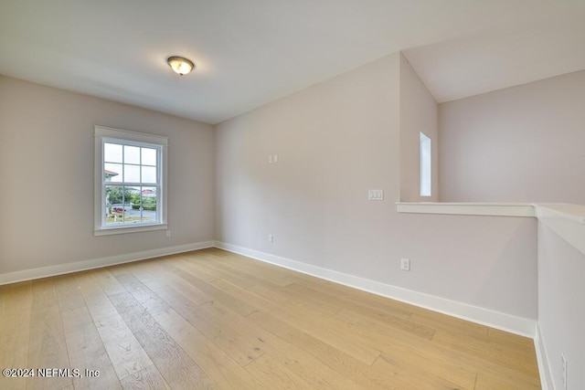 spare room with wood-type flooring