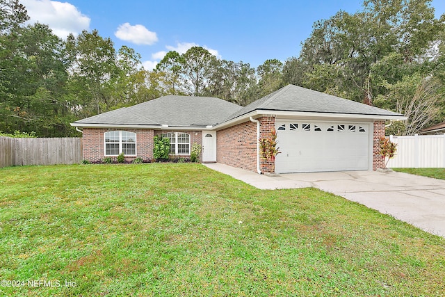 single story home featuring a front lawn and a garage