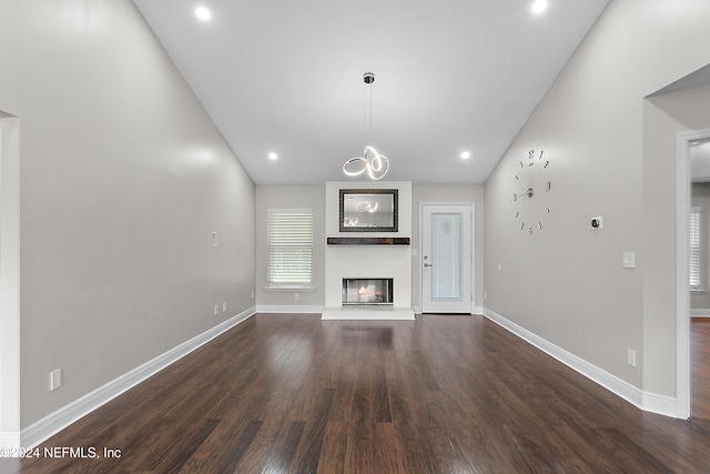 unfurnished living room with lofted ceiling and dark hardwood / wood-style floors