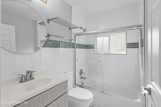 full bathroom featuring vanity, tasteful backsplash, toilet, and enclosed tub / shower combo