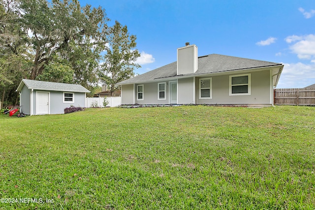 back of property featuring a lawn