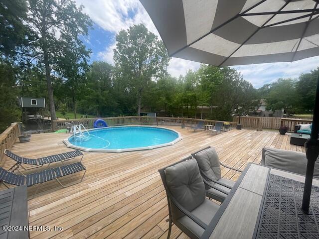 view of swimming pool featuring a wooden deck