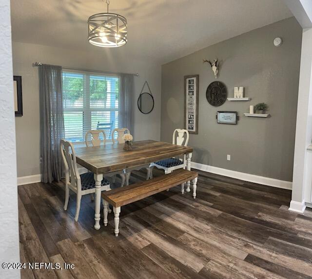 dining room with a chandelier and dark wood-type flooring