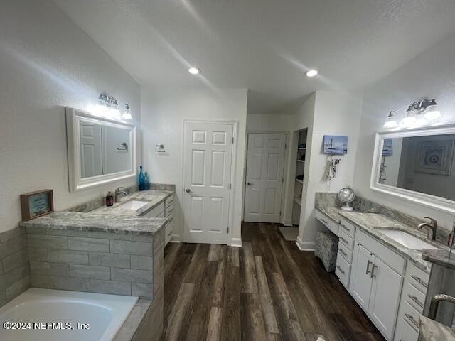 bathroom featuring a bathtub, wood-type flooring, and vanity