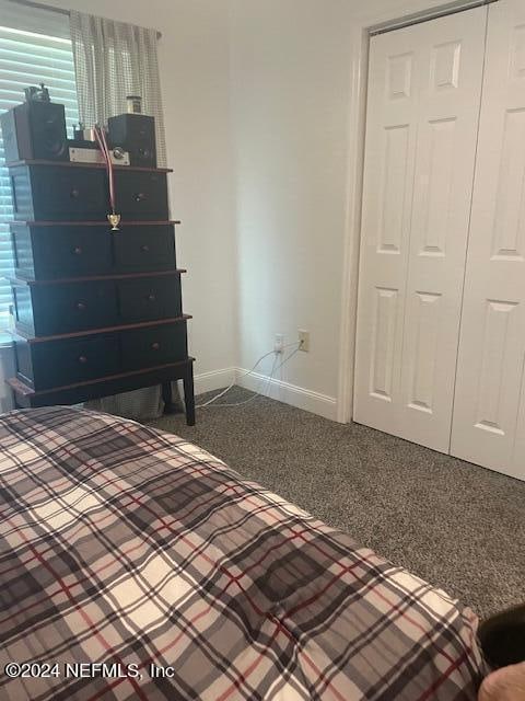 unfurnished bedroom with a closet and carpet flooring