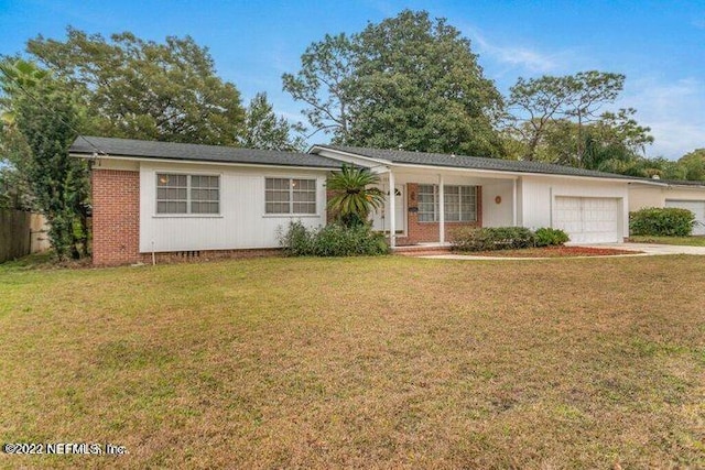 ranch-style house featuring a garage and a front lawn