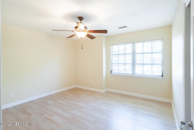 spare room featuring ceiling fan and light wood-type flooring