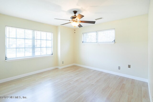 spare room with ceiling fan, light hardwood / wood-style floors, and plenty of natural light