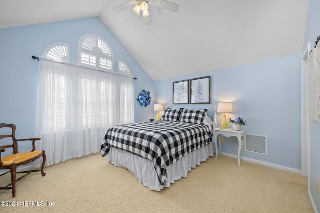 carpeted bedroom featuring vaulted ceiling and ceiling fan